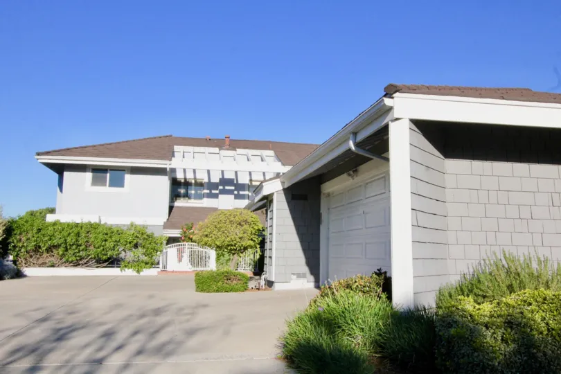 A two-storey residence in Willow Creek community with brown roofing.