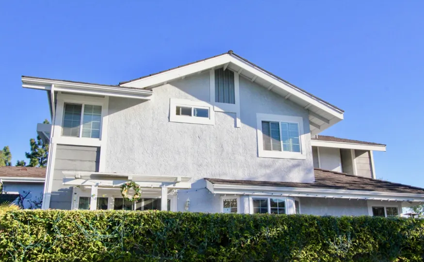 Simple stone home with white gates in Willow Creek, Irvine CA