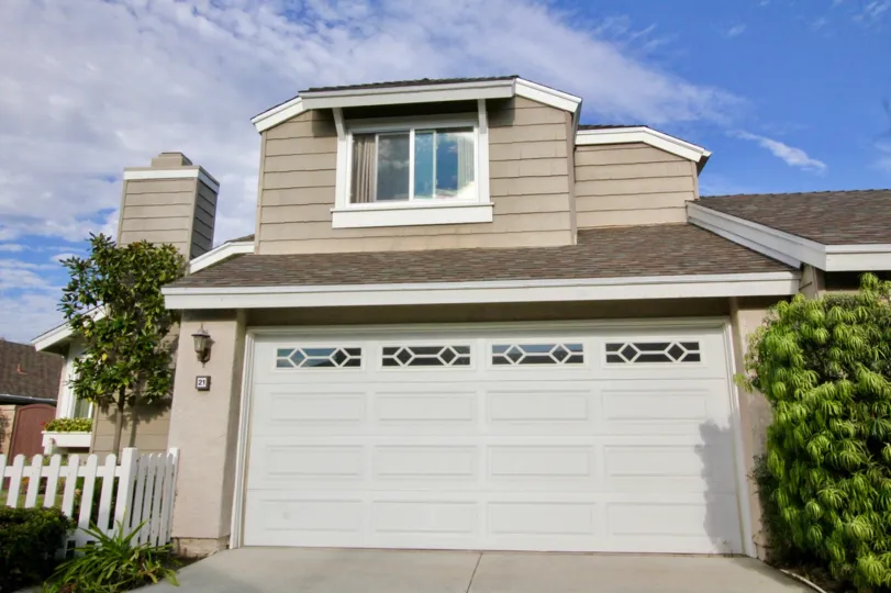 A sunny day in the area of Windwood Garden Homes, outside, garage, condo, tree, chimney