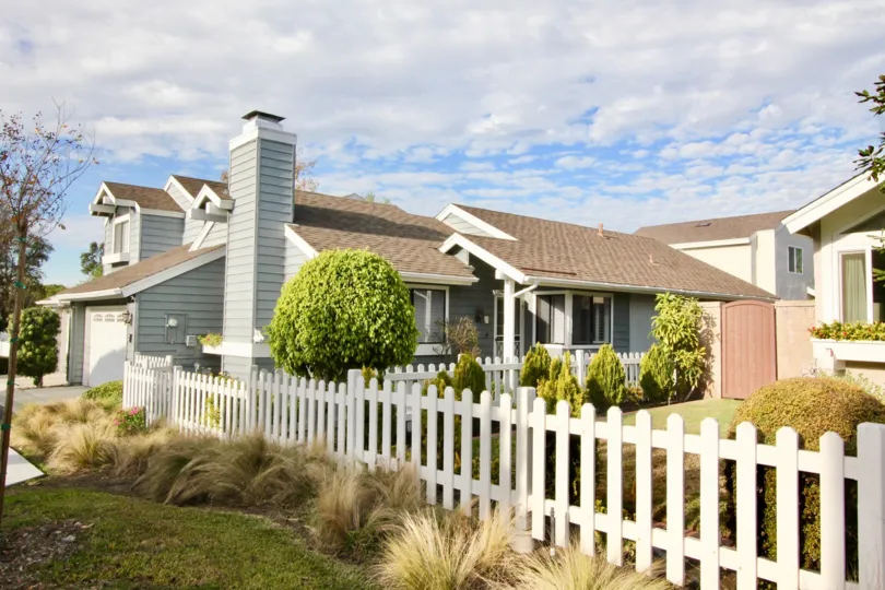 THE SIDE VIEW OF HOME LOCATED IN IRVINE CITY, WHICH HAVE THE LOT OF PLANTS, TREES, GRASSES