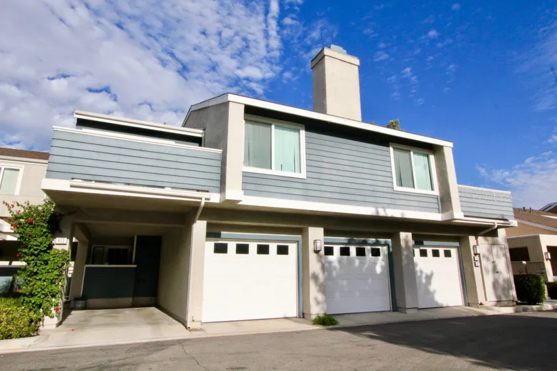 THE HOUSE IN THE WINDWOOD TOWNHOMES WITH THE SHUTTERS, PLANTS