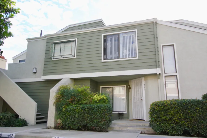 a pleasant day in the windwood town homes with a house that has steps in left side and garden in front