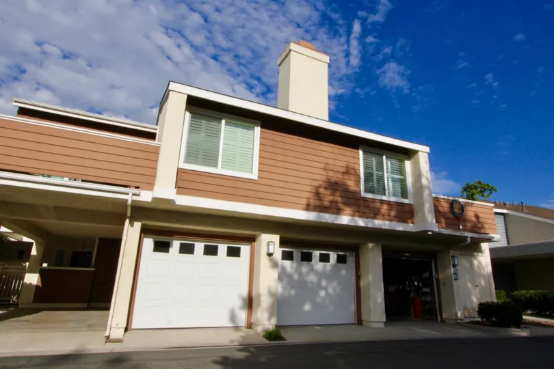 Brown townhome with chimney and attached garages at Windwood Townhomes in Irvine CA