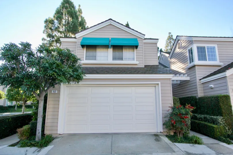 beautiful 2 story house with surrounded by trees and specious garage parkway