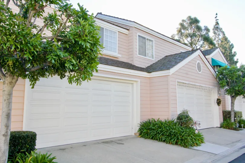 A two-storey unit in the Woodbridge Cove community with pinkish wooden cladding.
