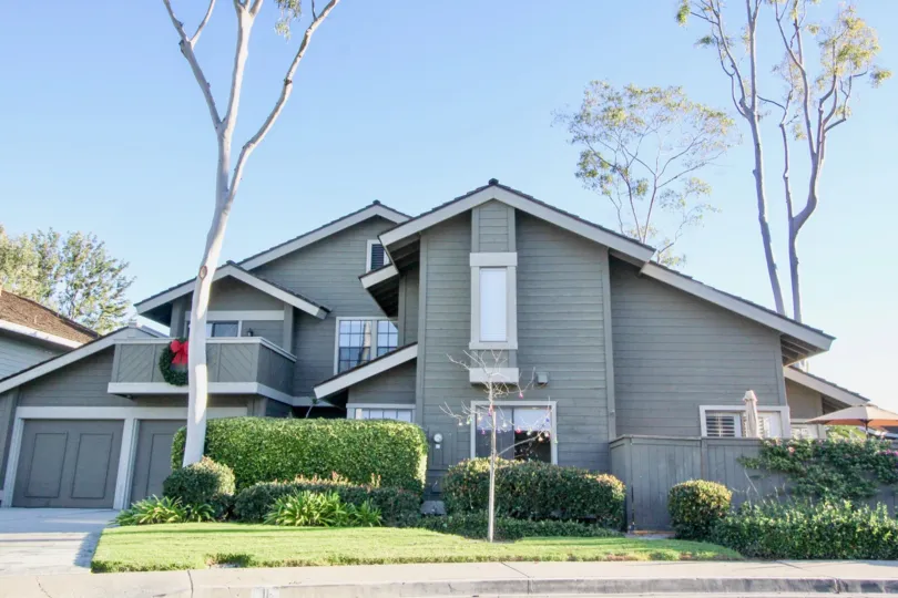 A two-storey residence in Woodbridge Crossing community painted in bluish-gray color.