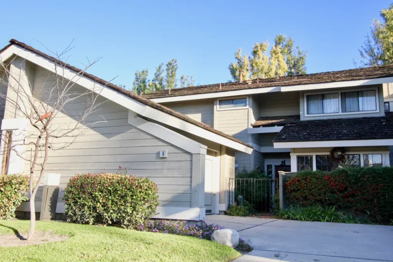 A two-storey residence in the Woodbridge Crossing community with highly pitched roof.