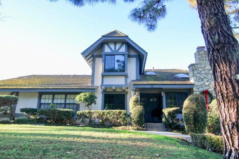 A single storied house with sloped roof and a large lawn in the woodbridge estates community
