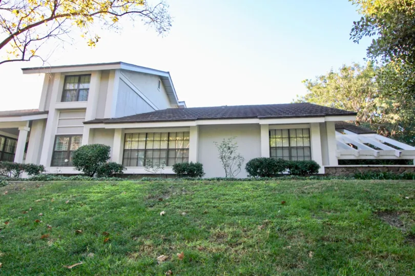 A two story town home with many windows on a hillside in Woodbridge Estates in Irvine CA