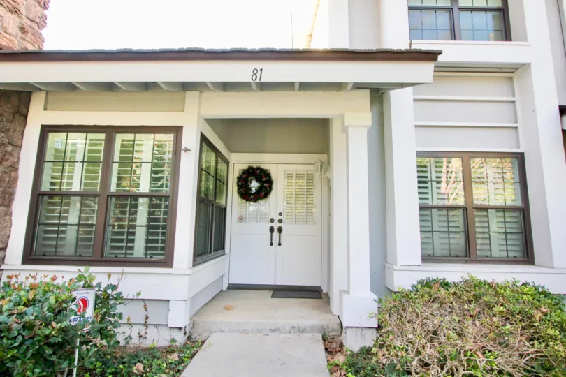 A front entrance in Woodbridge Estates community with louvered windows.
