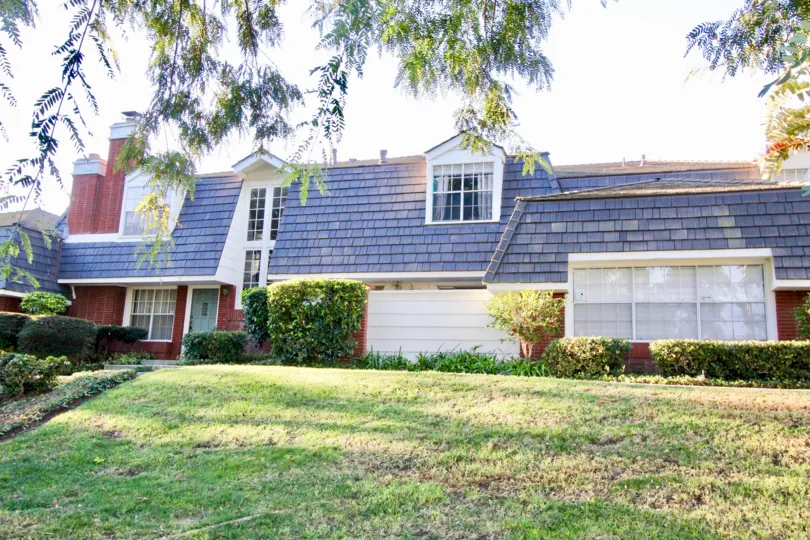 A two-storey townhouse in the Woodbridge Estates community with blue roofing.