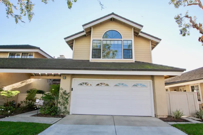 A two-storey residence in the Woodbridge Grove community with gable roofs.