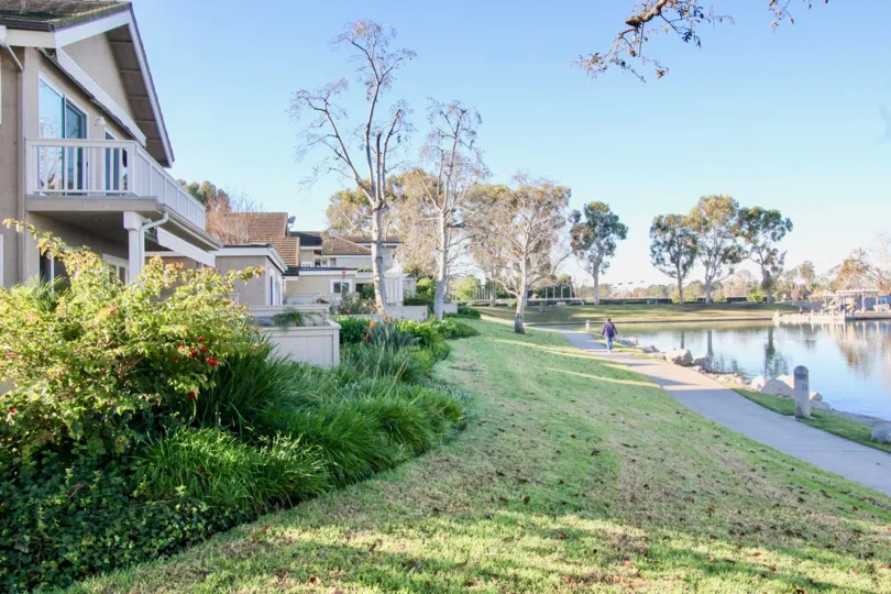 Awesome view of a lake near villas with lawn and trees in Woodridge Grove of Irvine