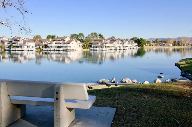 a warm day in the Woodbridge Grove with that has clear blue water and resting tables