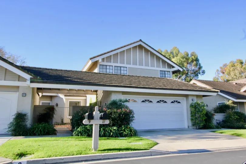 A sunny day in the area of Woodbridge Grove, outside, condos, garage, windows, roof, sky