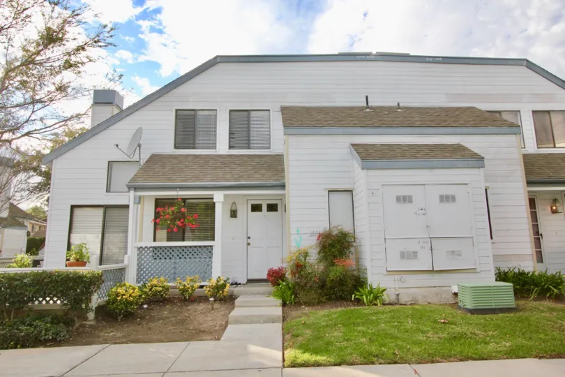 THE FRONT OF THE HOUSE WITH LAWN, CROTON PLANTS, FLOWERS DISH ARE THERE IN IRVINE CITY