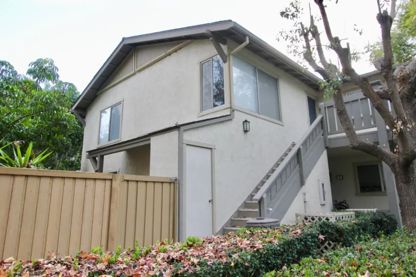 Two story condo homes with gray attached stairway in Woodbridge Reserve in Irvine CA