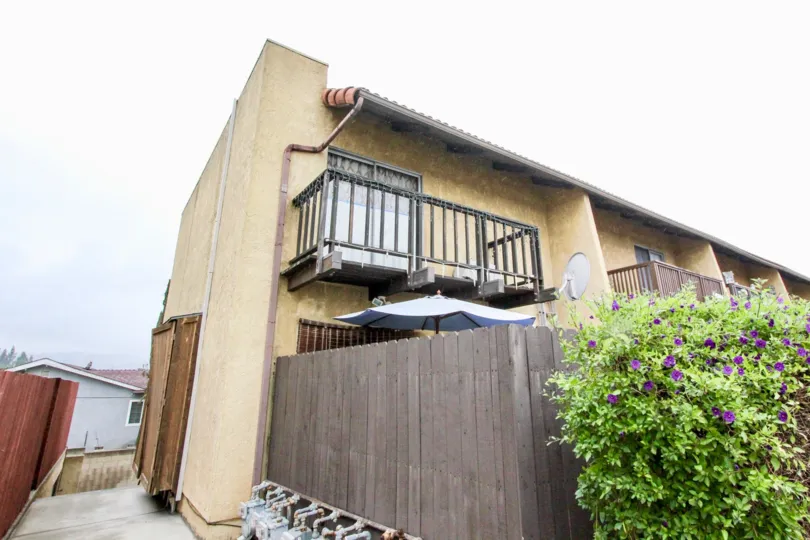 THE SIDEVIEW OF THE HOME LOCATED IN LA HABRA WHICH SHOW THE PLANTS WITH FLOWERS