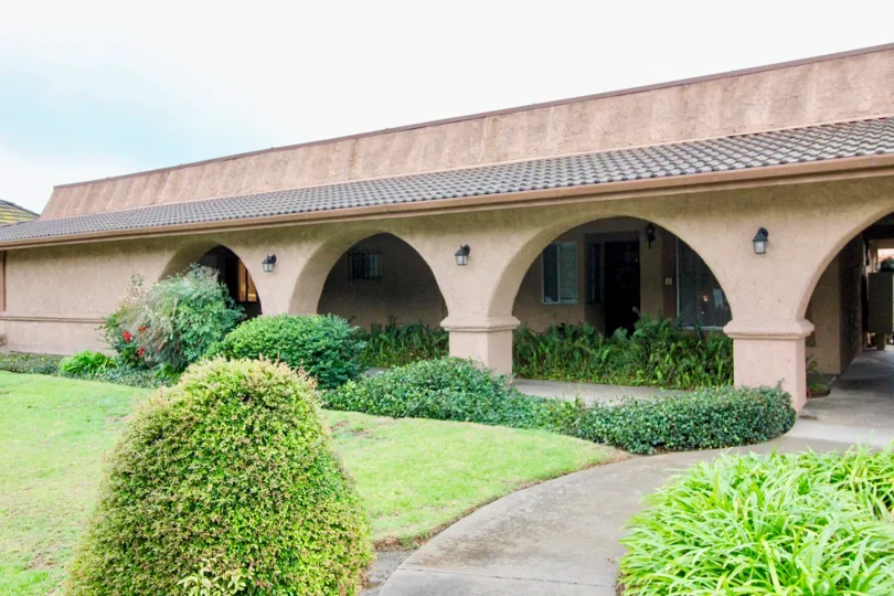 a pleasant day in the cerro del rey with a building that has 4 bridges and roofless top and garden around