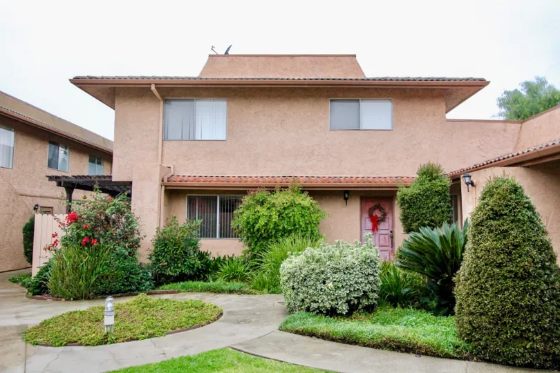 THIS PICTURE VIEWS THE HOME WITH LOT OF CROTON PLANTS WITH FLOWERS IN THE LA HABRA CITY