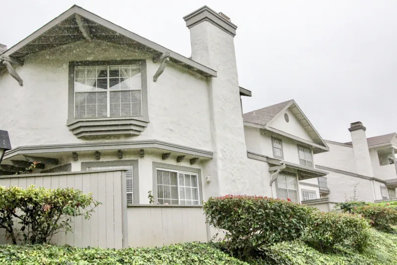 THIS IMAGE VIEWS THE HOUSE WITH PLANTS LIKE CROTONS ON THE FRONT LOCATED IN LA HABRA