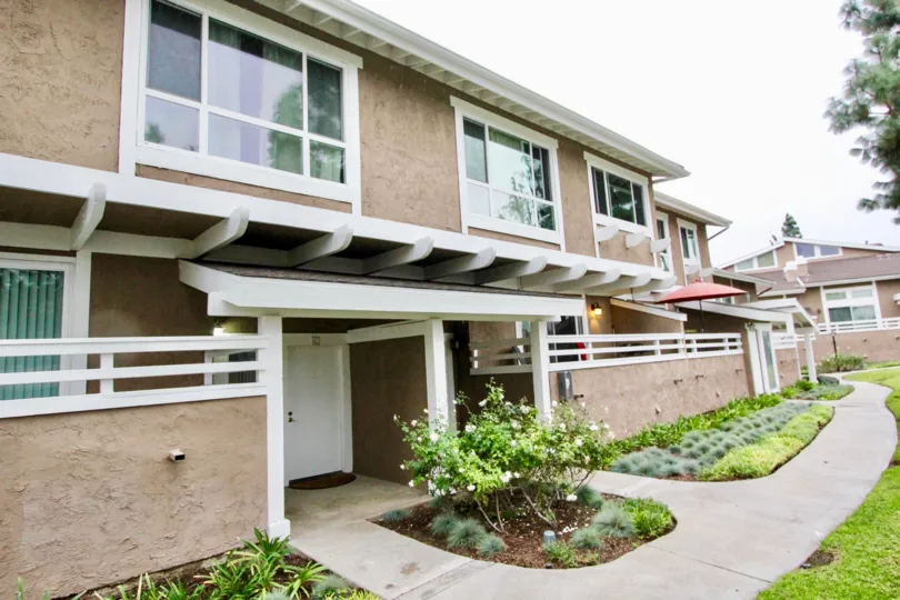 A sunny day in coyote creek with bewitching row homes and lawns, trees and plants