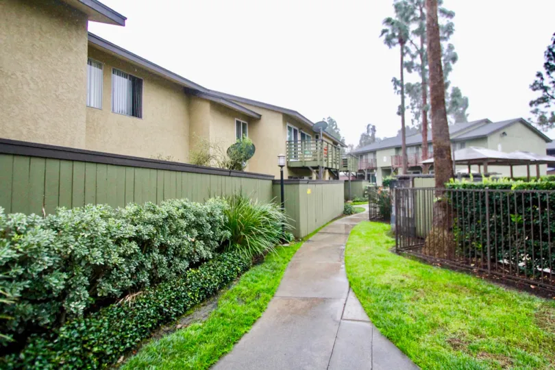 THE PICTURE SHOWS THE PATHWAY TO THE HOME, ON EACHSIDE LAWN, PLANTS ARE THERE IN CREEKSIDE VILLAGE COMMUNITY
