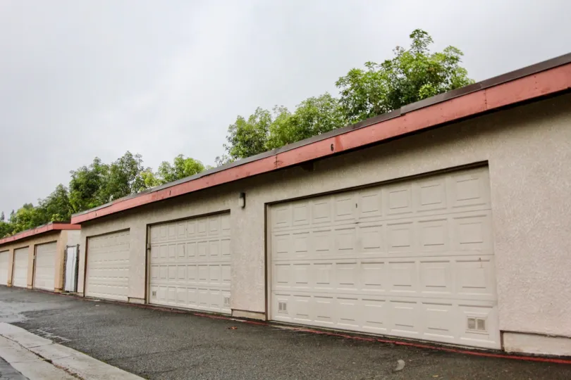 A PLEASANT DAY IN THE Fashion Heights WITH A BUILDING THAT HAS PARKING DOOR CLOSED and roof less top and back side trees