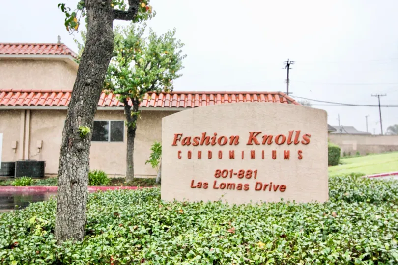Fashion Knolls represent in the wall placed between the bushes with trees in Fashion knolls