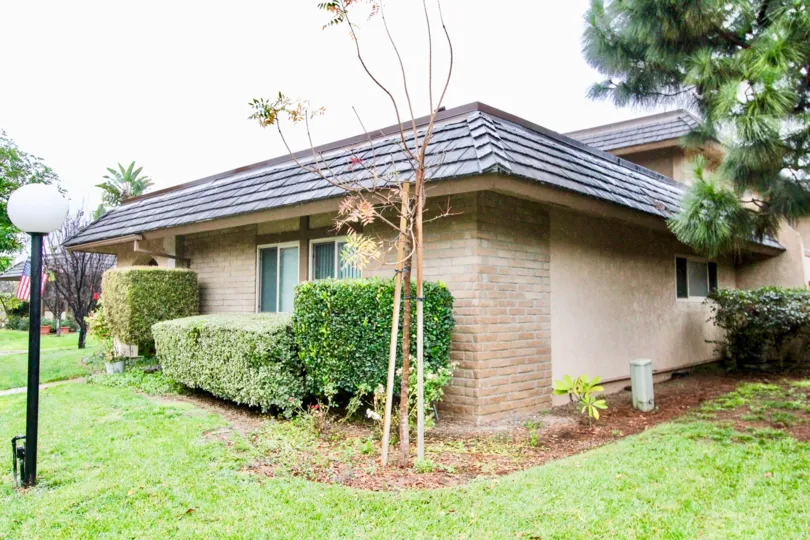 Villa with green lawn and lamp having trees beside in Fashion Walk of La Habra