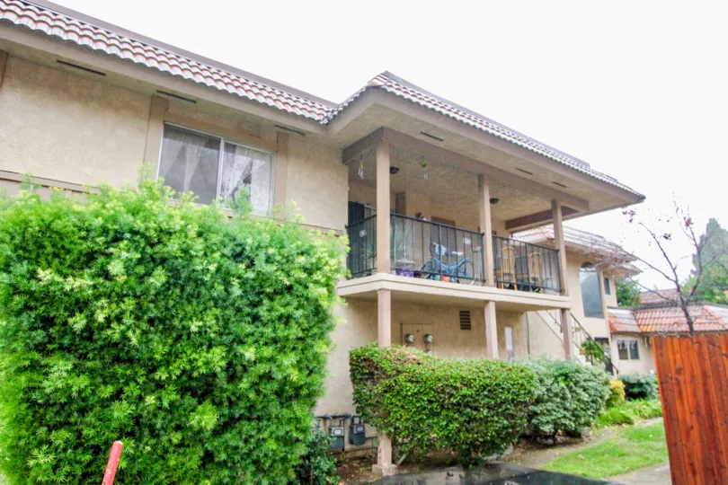 THIS IS FRONT VIEW OF THE HOUSE WITH LAWN, PLANTS BICYCLE IN PALCONY LOCATED IN LA HABRA