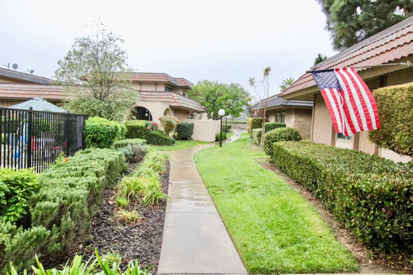 Fabulous view lawn and garden with USA Flag between villas in Fashion Walk of La Habra