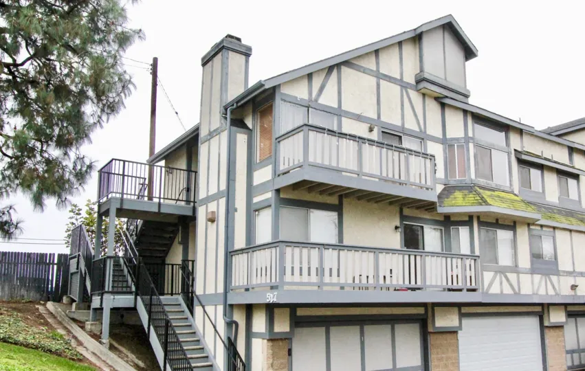 A PLEASANT DAY IN THE Heritage Walnut WITH A BUILDING THAT HAS ROOFLESS TOP AND BALCONY AND STEPS IN SIDE AND DOOR CLOSED