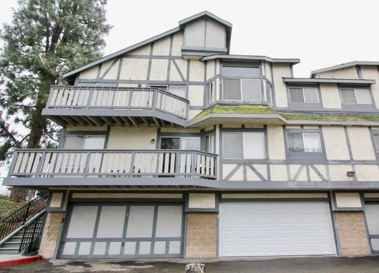 THIS IMAGE SHOWS THE APARTMENT WITH SHEDS IN LA HABRA THAT SHOWS THE TREES, GLASS WINDOWS