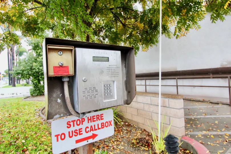 A call box that is located in the Idaho court with its background that is nature.
