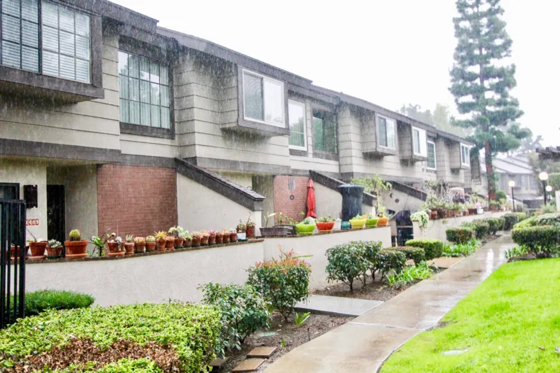 Group of Villas having nice glass windows and lamps with lawn in La Habra Woods Townhomes of La Habra