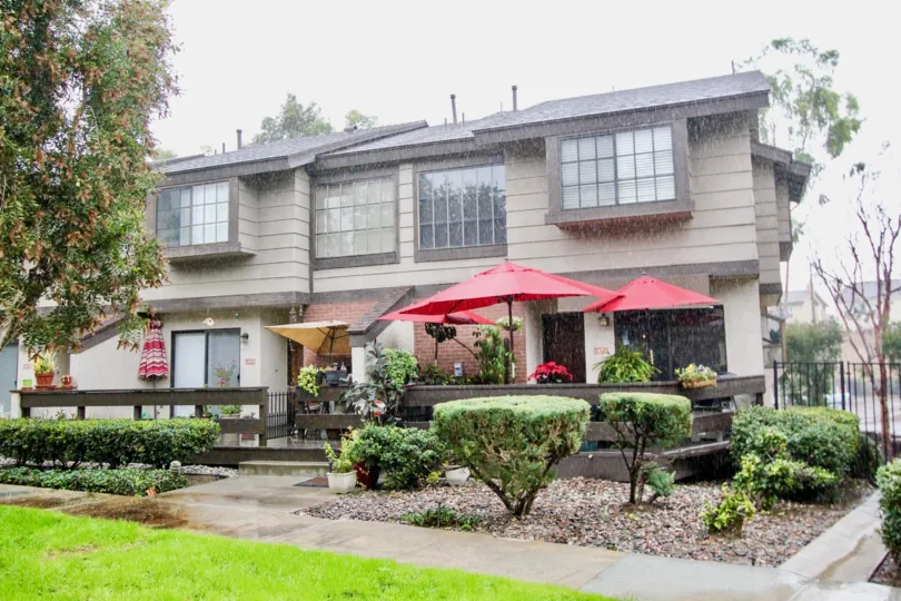 THE LARGE HOUSE WITH LOT OF PLANTS, TREES, UMBRELLAS, GLASS WINDOWS ARE SEEN IN LA HABRA CITY