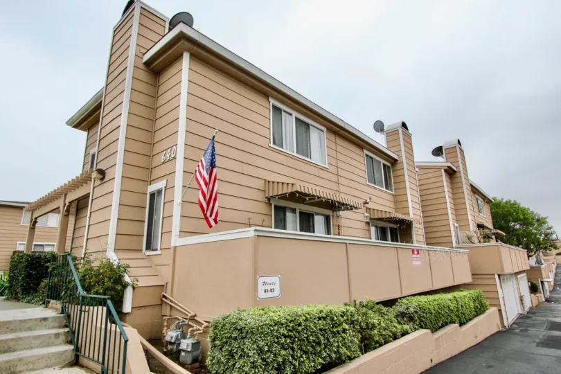THE FLATS WITH FLAG, NUMBER ON THE WALL, FRONT PLANTS, ROADWAY ARE THERE IN LA HABRA CITY