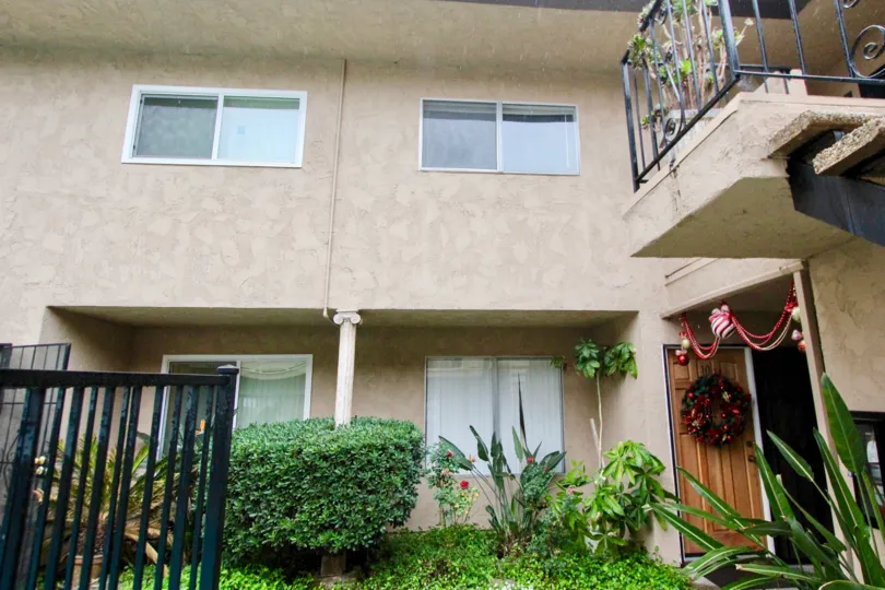 THIS IMAGE SHOWS THE HOUSE WITH LOT OF PLANTS LIKE CROTONS LOCATED IN LA HABRA