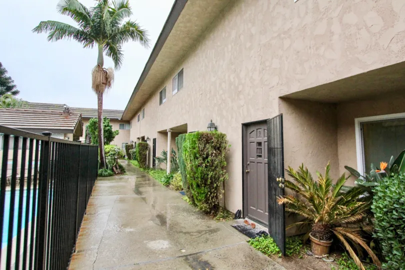 THIS IMAGE SHOWS THE CORRIDOR WITH LOT OF PLANTS LIKE CROTONS, TREES, ON THE LEFT SIDE SWIMMING POOL IS THERE LOCATED IN LA HABRA