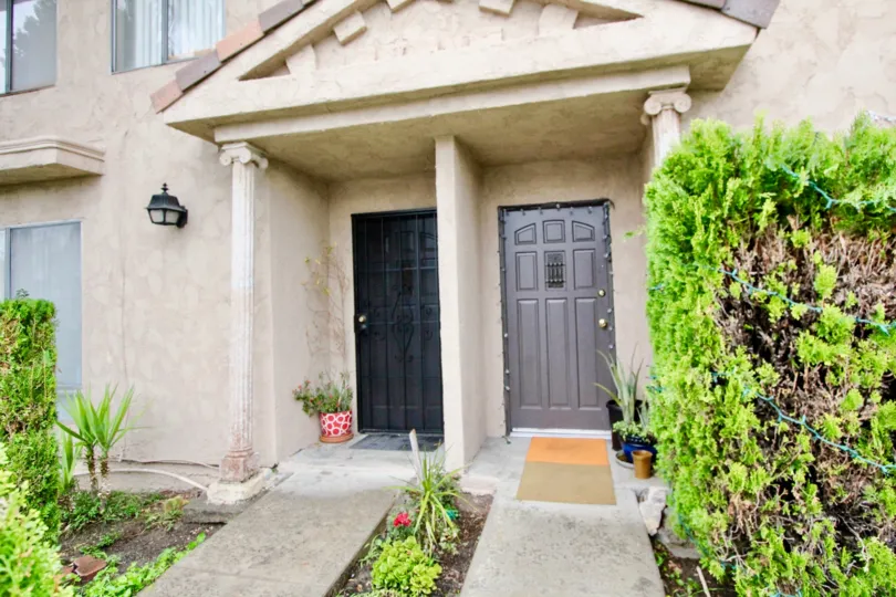 THE ENTRANCE OF THE HOME IS IN LA HABRA WHICH SHOWS THE PLANTS AND PATHWAY