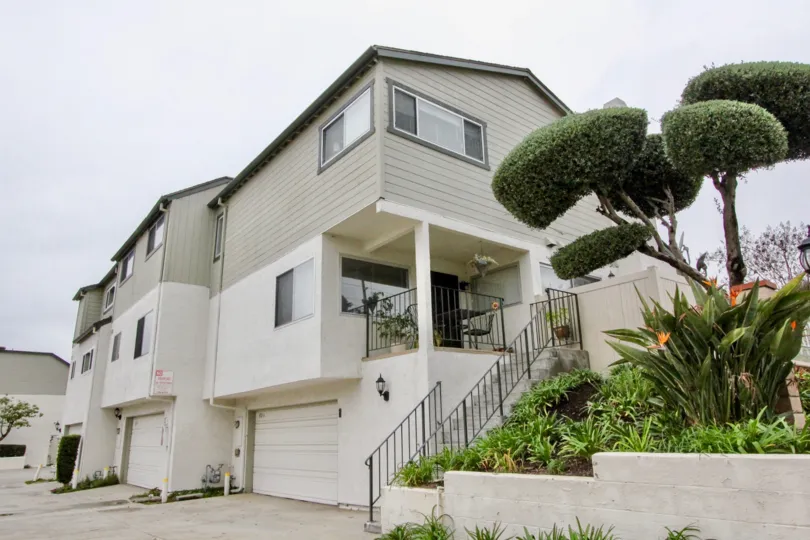 A house in lakeview townhomes with beautiful row homes surroundings full of green trees plants and street road