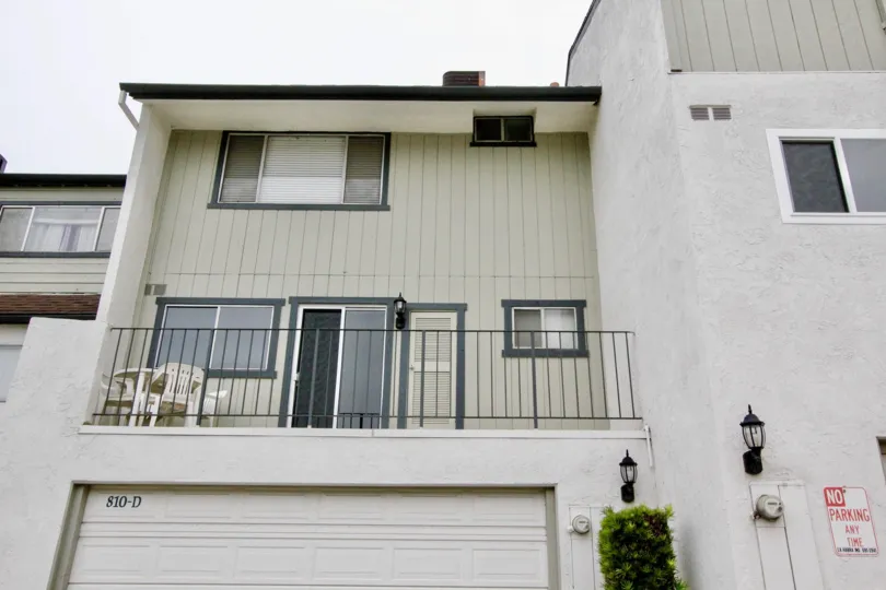 The cream colored Lakeview Townhomes building with balcony in front end