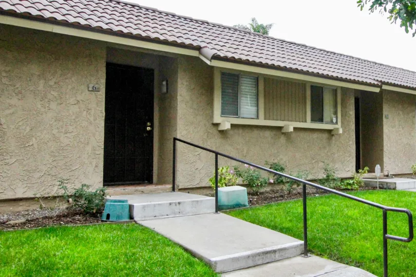 THE ENTRANCE OF THE HOUSE ON BOTH SIDE BEAUTIFUL LAWN IS THERE IN MIRA VISTA COMMUNITY