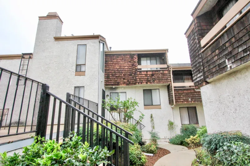 a pleasant day in the parkside town homes with a house that has steps in left and garden around