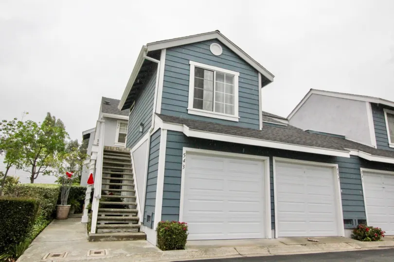 THE FRONT VIEW OF THE VILLA IN LA HABRA WHICH HAVE THE SHEDS, NUMBER ON THE WALL, ON LEFT SIDE CROTON PLANTS ARE THERE