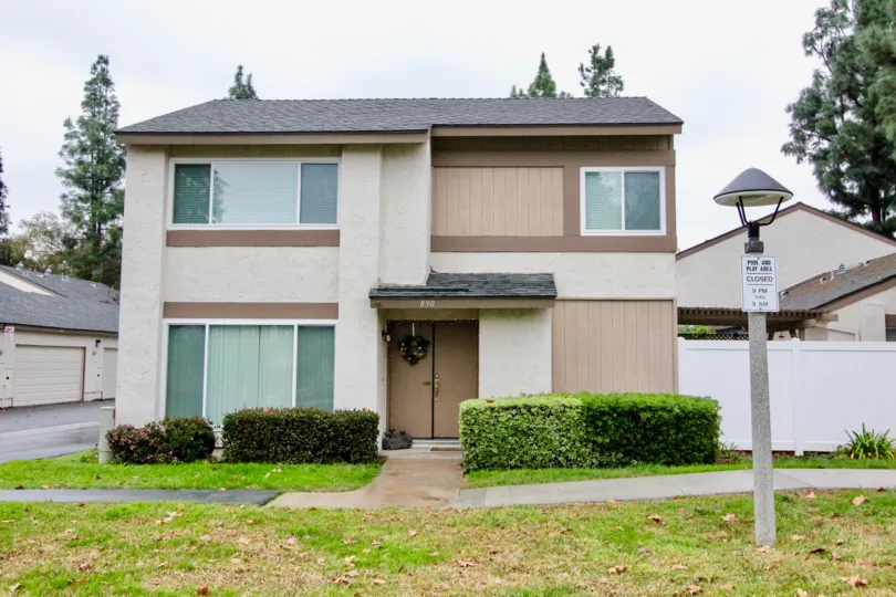 a pleasant day in the sunny hills village with a house that is numbered as 830 and has entrance door in the center