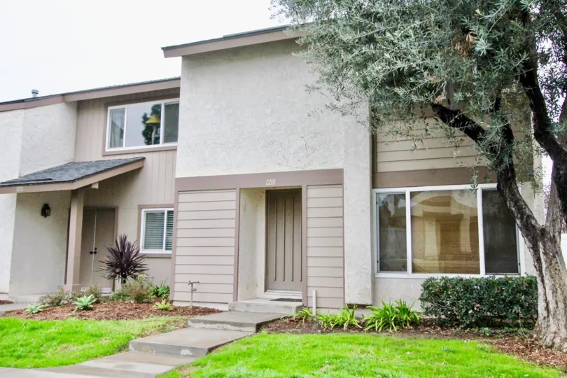 THE FRONT OF THE HOME WITH NUMBER ON THE WALL, ON BOTH SIDE LAWN, PLANTS, TREES THERE IN LA HABRA CITY