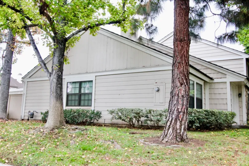 THE SIDE VIEW OF THE VILLA WITH LAWN, TREES PLANTS ARE LOCATED IN LA HABRA CITY
