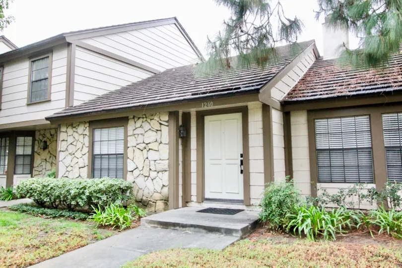 a rainy day in the gables with a house that has numbered as 1260 and roofless top and garden around